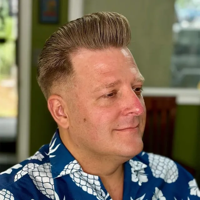 Classic blond pompadour with a clean taper.