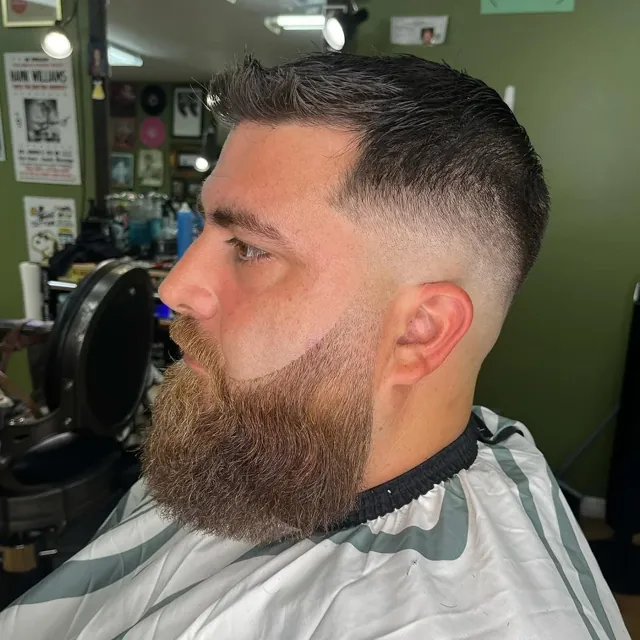 Skin fade with a full, shaped beard.
